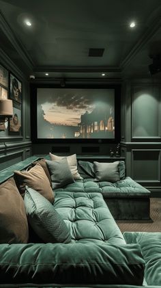 a green couch sitting in front of a projector screen on top of a wall