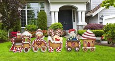 a group of christmas decorations sitting in front of a house