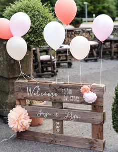 a wooden crate with balloons attached to it