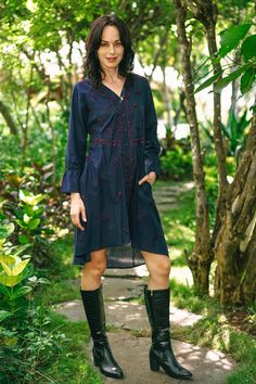 Maroon flowers bloom profusely on a background of navy blue in this pretty high-low shirtdress from designer Shalabh in India. Artisans craft the long-sleeved dress of 100% cotton, and cover the front with traditional chikankari embroidery blossoms. An embroidered button placket and waistline further accent the dress. Indigo Long Sleeve Dresses For Spring, Indigo Long Sleeve Dress For Spring, Indigo Long Sleeve Dress For Fall, Long Sleeve Floral Embroidery Shirt Dress For Spring, Long Sleeve Shirt Dress With Floral Embroidery For Spring, Embroidered Long Sleeve Shirt Dress For Spring, Spring Long Sleeve Embroidered Shirt Dress, Spring Floral Embroidery Long Sleeve Shirt Dress, Spring Embroidered Long Sleeve Shirt Dress