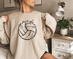 🏐This Game Day Volleyball Sweatshirt or Hoodie is the perfect gift for everyone! Your orders made with the highest quality materials and are super soft, comfy and cozy!! 🏐 🟢HOW TO ORDER 🟢 1. Check and Review ALL Photos 📷 2. Select Your Sweatshirt/Hoodie Size and T-Shirt Color from drop down menus ✨ 3.Select Your Design Print Color from images and mention in personalization section 🎨 4. Add to cart & place order 🛒 We're constantly striving to provide excellent service. We'd love to get you Volleyball Sweatshirts, Game Day Sweatshirt, Volleyball Shirt, Volleyball Mom, Volley Ball, Basketball Shirts, Sports Shirt, Sweatshirt For Women, Game Day Shirts