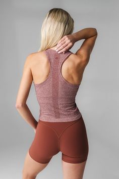 Our Energy Tank is designed for high performance activities as well as for on the go. This seamless tank is fitted yet flexible and hits at the top of the waistband. Seamless Racerback Activewear With 4-way Stretch, Micro-elastic Gym Tops With Go-dry, Versatile Compression Racerback Tank Top, Breathable Micro-elastic Yoga Top, Breathable Micro-elastic Workout Tops, Micro-elastic Go-dry Top For Workout, Sleeveless Seamless Gym Activewear, Versatile Workout Tops, Compression Seamless Tank Top For Workout