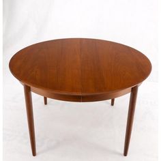 an oval wooden table with two leaves on the top and one leaf at the bottom