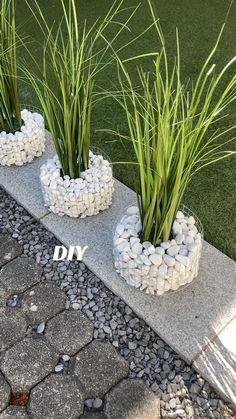 some grass and rocks are in the shape of flower pots