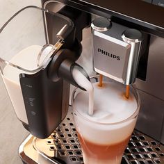 an espresso machine with milk being poured into it