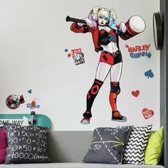 a living room with a couch and wall decals on the walls, including a harley girl