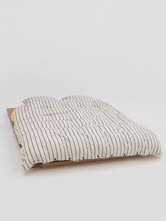 a dog bed made out of wood and ticking fabric