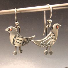 Whimsical bird earrings in mixed metals of copper and argentium sterling silver are unique and fun earrings with a bit of bohemian spirit for those that love handcrafted art jewelry that speaks to the soul.  We have oxidized and polished them to highlight and provide contrast, depth and interest between the metals and to the detailing of the riveted copper eye, sleek wing and the stamped feet. A great gift for a bird or nature lover or enthusiast along with those interested in Ornithology.  Hand Artistic Silver-colored Copper Earrings, Artistic Silver Copper Earrings, Handmade Sterling Silver Bird-shaped Jewelry, Unique Silver-colored Copper Earrings, Unique Silver Jewelry With Bird Design, Copper Eye, Silver Bird, Handcrafted Art, Bird Earrings