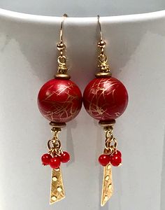 "Vintage Japanese Cherry Red Gold Drizzle Lucite Beads, Vintage Japanese Red Beads, Vintage German Gold Glass Spacer Beads, Vintage Gold Plated Triangular Dangles Raised Dots, Gold Plated French Ear Wires Whimsical BOHO long dangling earrings feature bright red vintage Japanese lucite beads in two sizes combined with gold elements for sparkle. The large red bead at the top is approximately 5/8\" in diameter with gold drizzle - each bead is different in terms of the pattern of gold. This vintage Vintage Red Jewelry With Dangling Beads, Festive Earrings With Gold Beads, Artisan Red Dangle Earrings, Artisan Red Teardrop Earrings, Vintage Red Earrings For Festive Occasions, Artisan Red Beaded Earrings, Vintage Gold Beaded Earrings With Dangling Beads, Red Drop Beaded Earrings For Celebration, Red Beaded Dangling Earrings For Festivals