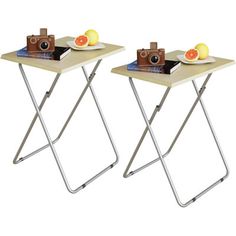 two small tables with trays on each side and one has an orange slice in the middle