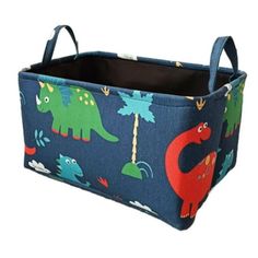 a blue fabric storage bin with dinosaurs on it