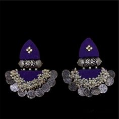 The Rupira Purple Fabric Earrings is a lightweight earring made of fabric , kundan and gajra pearls in silver finish. This one of a kind earring is surely going to make a statement with any Indian or Western outfit. Specifications Materials used: Fabric, Kundan, Gajra Pearls Weight: 30.6 grams At Romikas, we pride ourselves on the craftsmanship and high quality of our jewelry, designed to enhance your natural beauty. Please contact us with any questions. Handmade Danglers For Navratri, Traditional Purple Beaded Earrings For Festivals, Silver Cutdana Danglers For Party, Handmade Danglers For Navratri Festival, Silver Danglers With Cutdana For Party, Silver Party Danglers With Cutdana, Silver Beaded Earrings With Latkans, Festive Beaded Latkan Earrings, Handmade Chandbalis For Festival