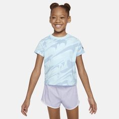 This colorful, Swooshtastic tee is sure to put some pep in your kiddo's step! It's made of cotton jersey, has a tagless crewneck for a comfy feel and the boxy cut creates a flattering, cropped look. Pair with the Nike Dri-FIT Prep in Your Step leggings for a coordinated style tailored for play. Blue Graphic Print Activewear With Short Sleeves, Summer Athleisure T-shirt For Playwear, Nike Short Sleeve Activewear, Blue Moisture-wicking T-shirt For Spring, Spring Blue Moisture-wicking T-shirt, Playful Nike Crew Neck T-shirt, Playful Sports T-shirt For Summer, Sporty Cotton T-shirt For Playwear, Sporty Graphic Print Tops For Playwear