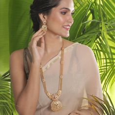 The gold beaded chain necklace that sizzles the room, this long necklace is royal charm. Excellent to pair with a kanjivaram or handloom saree. Specification: Weight - 100 gm (necklace); 19 gm (earring); Length - 36 cm (necklace); 8 cm (earring), 100% Satisfaction Guarantee:  1 Year Warranty, Long Lasting Plating, High-Quality Stones. Gifting:  This Indian long necklace set comes in a beautiful Tarinika gift box, making it an ideal gift for birthday, wedding anniversary or wedding gift.  Occasion: Perfect choice for any Indian occasion.  Care: It is advisable that you keep Tarinika products away from direct heat, humidity, and moisture. It is best to preserve your Tarinika jewelry in the box. Return/Exchange Policy:  We provide 14 days return/exchange policy. Contact us for any questions. Antique Long Necklace, Indian Long Necklace, Indian Jewelry Set, Long Necklace Set, Gold Necklace Indian, Necklace Set Indian, Indian Necklace, Indian Jewelry Sets, Diamond Solitaire Necklace