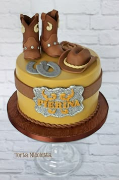 a cake decorated with cowboy boots and horseshoes