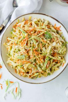 a white bowl filled with coleslaw and carrots