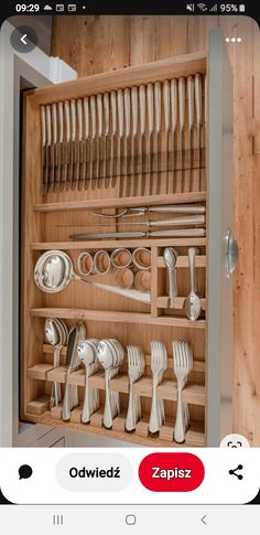 a wooden cabinet filled with lots of silverware