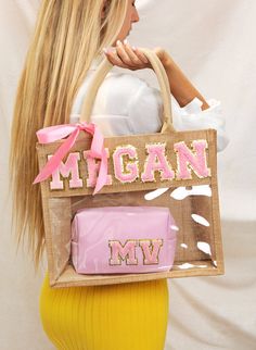 a woman holding a bag with the word michigan on it