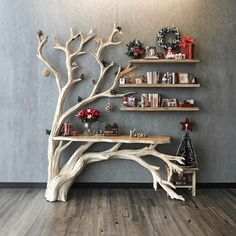 a wooden tree shelf with christmas decorations on it