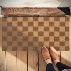 a woman standing on top of a wooden floor next to a piece of wood that has been cut in half