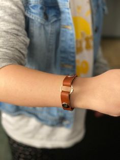 a person wearing a bracelet with two rings on it