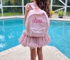 Personalized items make the most memorable gifts. Great birthday, Christmas, travel gift.  *Dimensions: 13.77" x 9.05" x 4.72" *One Size *Product weight 0.57 lbs *Available colors: Black, Olive Green, Pistachio, Powder Pink, Powder Blue  *Material: Polyester *Sponge clean only *Pictured girl is 10 years old  Features: Zippered front pocket Padded back panel Grab handle Fully adjustable shoulder straps ----------------------------------------------------------------------------------------------- Embroidery Instructions, Pink Powder, Christmas Travel, Black Olive, Original Bags, Powder Pink, Color Samples, Font Styles, Kids Backpacks