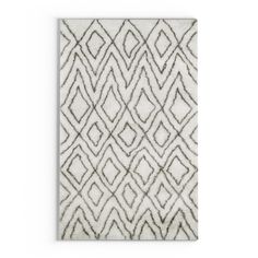 a white rug with an abstract design on the front and back of it, in grey tones