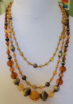 21 inch amber topaz and gold 3 strand beaded necklace  Unmarked This is a vintage item and may have some signs of wear.  I will do my best to describe any issues If you are unhappy with your purchase, please let me know and I will do my best to fix it. Vintage Multi-strand Layered Necklace For Gifts, Vintage Amber Beaded Necklace, Vintage Amber Round Bead Jewelry, Vintage Gold Beaded Necklaces With Faceted Beads, Vintage Double Strand Gold Layered Necklace, Vintage Gold Beaded Necklace With Faceted Beads, Adjustable Vintage Gold Beaded Necklace, Vintage Amber Beaded Necklaces, Vintage Multi-strand Necklace With Faceted Beads