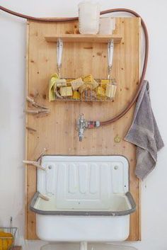 a white toilet sitting next to a wooden shelf