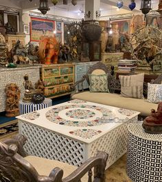 a room filled with lots of different types of furniture and decor on top of wooden flooring