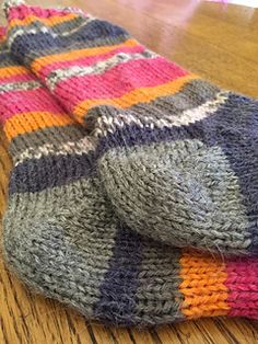 a pair of socks sitting on top of a wooden table