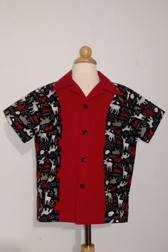 Boys button down shirt size Small 6-8 is ready to ship! Size Small 6-8 body measurements would be 25-27 inches in the chest and 26-28 inches in the hips. Finished garment measures 18 inches from the bottom of the collar to the hem. Winter theme short sleeve button down shirt with a red collar and center front. This shirt would be perfect for Christmas holidays. Great for family pictures and there is also a matching outfit for sister! See listings. This shirt would look great with black dress pants or jeans! Patterns often differ from brand to brand. Please refer to child's body measurements and finished garment measurements to determine your child's size. Complete size chart is available for viewing under frequently asked questions. Machine or hand wash in cold water, gentle cycle. Line or Fitted Short Sleeve Christmas Top, Fitted Short Sleeve Tops For Holidays, Festive Red Short Sleeve Shirt, Festive Casual Short Sleeve Shirt, Family Matching Fitted Shirt With Short Sleeves, Red Short Sleeve Shirt For Festive Occasions, Casual Festive Short Sleeve Shirt, Red Casual Festive Shirt, Casual Red Festive Shirt