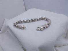 This is a vintage sterling silver bead balls bracelet. This geometric bead ball bracelet is stamped FNA Italy & measures 7" long. Weight is 17 grams. Silver Pearl Bracelet With Round Beads, Silver Pearl Bracelet With 8mm Beads, Formal Silver Ball Chain Jewelry, Silver Metal Jewelry With 8mm Beads, Vintage Silver Bracelets With Round Beads, Silver Beaded Bracelets With Ball Chain, Silver Metal Beaded Bracelets With 8mm Beads, Silver Jewelry With Ball Chain And Round Beads, Silver Rosary Bracelet With Spacer Beads