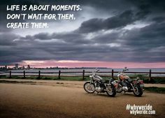 two motorcycles parked next to each other in front of a fence with the words life is about moments, don't wait for them create them