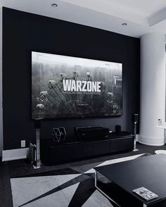 black and white living room with large poster on the wall, coffee table and couch