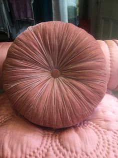 two pink pillows stacked on top of each other