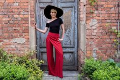 Elegant high-waisted wide leg trousers with asymmetric overlay. Looks like pants skirt - very unique! This elegant palazzo pants has side-seam hidden zipper. Pair it with our red jacket to have amazing red suit! Its is made upon request, so we need 14 days to make and ship. SIZING in centimetres: XS: waist 64, hips 96, length 95 S: waist 68, hips 100, length 95 M: waist 72, hips 104, length 95 L: waist 76, hips 108, length 95 XL: waist 80, hips 112, length 95 in inches: XS: waist 25,2, hips 37,8 Romantic Lace Blouse, Elegant Backless Dress, Grey Tulle Skirt, Evening Pants, Lace Top Wedding, Bridal Bodysuit, Elegant Trousers, Trousers High Waisted, Pants Elegant