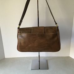 "This Liz Claiborne Faux Croc Leather Shoulder Bag In Caramel is in very good condition. There are no stains, tears, missing stitches, or apparent signs of wear. The exterior of the bag is croc stamped polyvinyl. There is a large slip pocket on the back of the bag. The hardware is gold tone. The interior is lined with tan polyester fabric. It has one zippered pocket and two slip pockets. This bag measures approximately: Width: 11\" Height: 7.0\" Depth: 5.0\" Strap drop: 10\" This is a unique, an Retro Brown Soft Leather Shoulder Bag, Vintage Brown Flap Shoulder Bag, Vintage Tan Satchel Shoulder Bag, Vintage Brown Flap Satchel, Brown Textured Leather Shoulder Satchel, Timeless Bags, Beaded Evening Bags, Croc Leather, Hand Beading