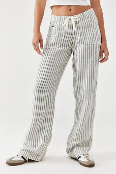 Pinstripe-topped straight-leg pants by BDG, a breezy linen style for easy warm-weather wear. Cut to a low-rise waist with a drawstring fastening, belt loops, five-pocket styling and a loose fit through the leg. Exclusive to Urban Outfitters. Content + Care 100% Linen Machine wash Imported Size + Fit Model is 171cm/5'7.5" and wearing size Small Inseam: 80cm Leg opening: 26cm Measurements taken from a size Small Use our size guide to check how this product fits | BDG White Pinstripe Five-Pocket Linen Pant in White, Women's at Urban Outfitters Casual Spring Bottoms With Vertical Stripes, Casual Wide-leg Pants With Vertical Stripes, Casual Striped Relaxed Fit Bottoms, Relaxed Fit Striped Casual Bottoms, Casual Vertical Stripes Bottoms For Loungewear, Casual Linen Bottoms With Vertical Stripes, Beach Wide Leg Bottoms With Vertical Stripes, Beach Bottoms With Vertical Stripes And Wide Leg, Casual Striped Pants For The Beach