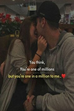 a man kissing a woman on the cheek while sitting in a booth at a restaurant