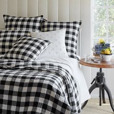 a black and white checkered comforter set on a bed