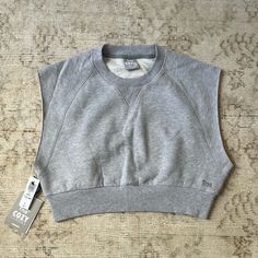 Aritzia Tna Cozy Perfect Crop Sweatshirt. New With Tags, Never Worn! The Color Is Heather Chrome. Would Be So Cute With Sweat Shorts. Sweatshirt Material With Cutoff Sleeves Like A Muscle Tee Kind Of. Comfortable Cotton Tops With Cozy Fit, Comfortable Cozy Fit Cotton Top, Cozy Fit Comfortable Cotton Tops, Cozy Cotton Tops For Everyday, Cozy Cotton Everyday Tops, Cozy Everyday Cotton Tops, Comfy Stretch Tops For Layering, Comfy Cotton Everyday Tops, Comfy Cotton Tops For Everyday