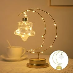 a light that is on top of a table next to a cup and saucer