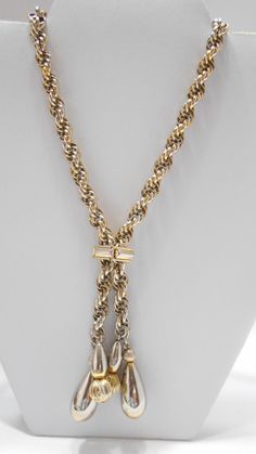 "Vintage gold tone 28\" lariat chain necklace. Intertwined chain links. Pullover necklace...no fastener. Four gold tone dangles. Necklace is adjustable with a square gold tone metal attachment. Classic necklace. Excellent condition. Unsigned." Metal Lariat Necklace With Adjustable Dangle Chain, Adjustable Metal Lariat Necklace With Dangle, Formal Lariat Toggle Necklace With Chain, Formal Lariat Toggle Necklace, Metal Lariat Necklace With Chain, Metal Lariat Necklace With Chain Detail, Metal Lariat Necklace, Long Chain Lariat Necklace For Formal Occasions, Formal Lariat Chain Necklace