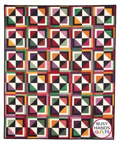 a multicolored quilt with squares on it