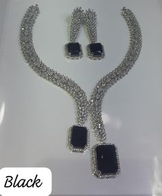 Faux CZ Diamonds Black Necklace Earrings, Bridal Dangler Earrings, Bridal Choker, Party Wear Silver Necklace Earrings, Statement Piece ITEM DESCRIPTION Metal        = Silver Plated Occasion  = Wedding, Party Wear, Bridal Color        = White and Black Size          = Necklace Length = 7 Inches Long, Earring Size = 2.5 Inches Long,  Free Shipping 100% Satisfaction Guarantee: 1 Year Warranty, Long Lasting Plating, High-Quality Stones Occasion: Perfect choice for any Indian occasion.  Care: It is a Black Glamorous Jewelry For Formal Occasions, Black Glamorous Formal Jewelry, Party Jewelry Sets With Matching Dangle Earrings, Glamorous Black Formal Jewelry, Party Dangle Necklaces With Matching Earrings, Glamorous Hand Set Jewelry For Party, Black Cubic Zirconia Jewelry For Party, Elegant Black Necklace For Celebration, Party Jewelry Sets With Matching Cubic Zirconia Earrings