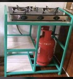 a stove with a red fire extinguisher next to it