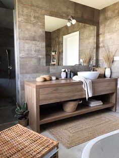 a bathroom with a sink, mirror and bathtub