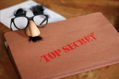 a top secret book with a fake mustache and eyeglasses on it