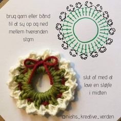 a crocheted brooch sitting on top of a piece of paper next to an ornament